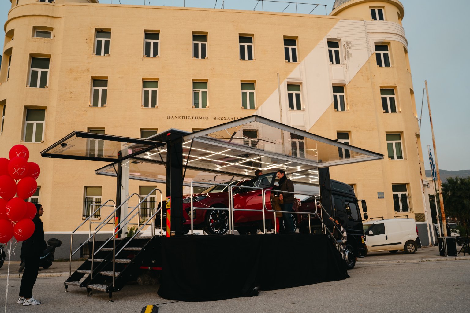 bmw x2 inside a transparent exhibition truck in Greece