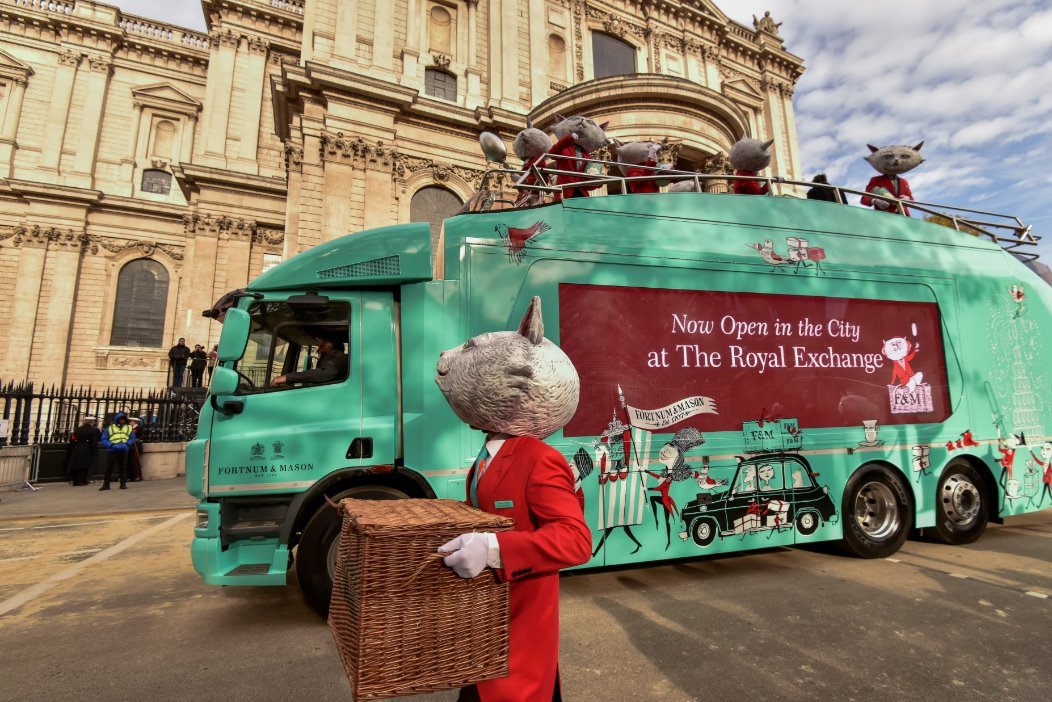 ShowTruck with Fortnum and Mason branding at Lord Mayor's Show London with Christmas themed wrap character props on upper deck and St Pauls Cathedral in background