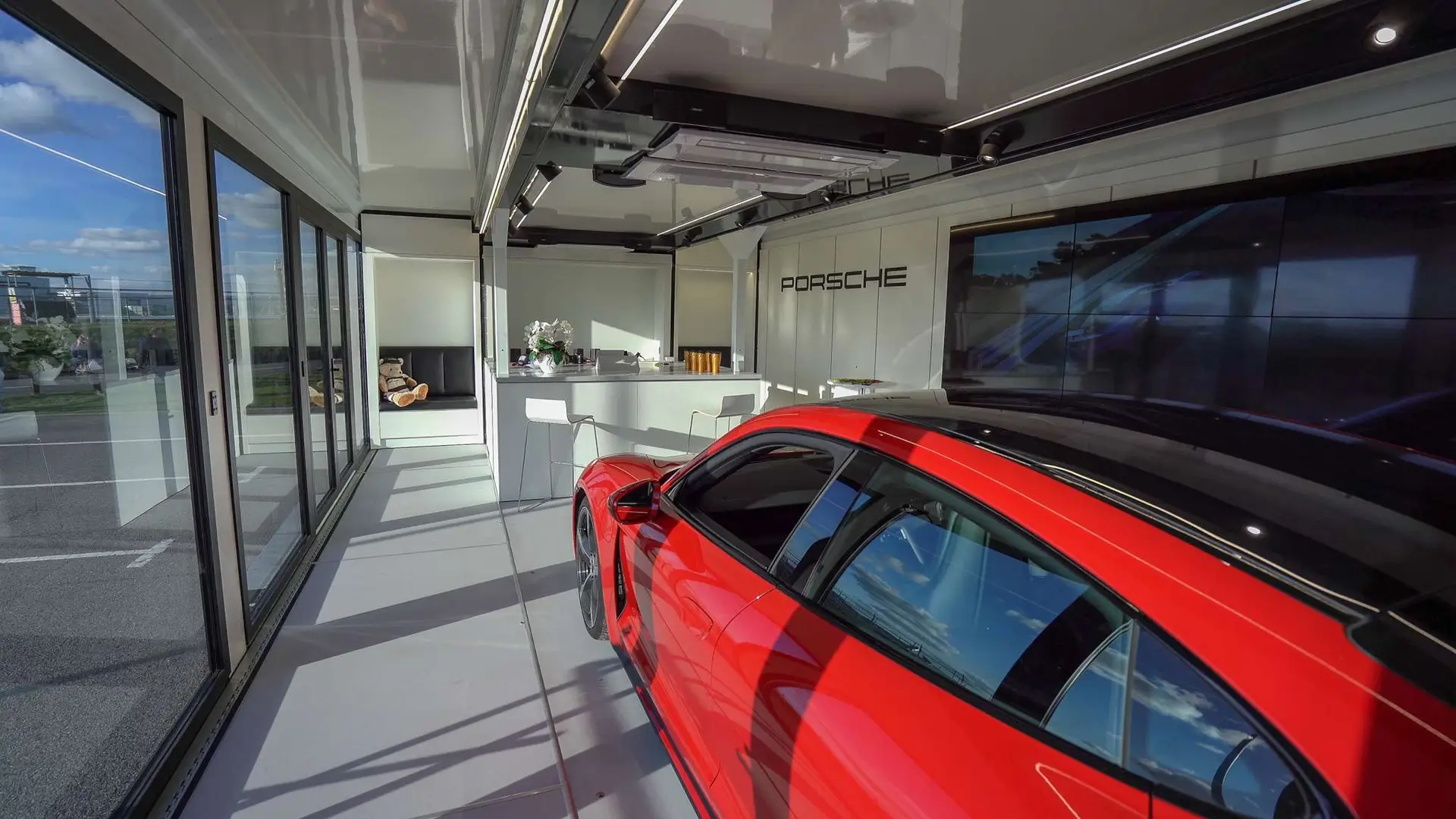The Clear Idea Pulse Drop Deck hospitality trailer interior detail — Bose audio, LED illumination, and premium finishes for the Porsche Taycan activation