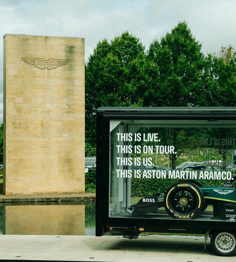 Aston Martin Aramco F1 car displayed inside The Clear Idea Transparent Showcase Trailer at UK heritage venue tour stop