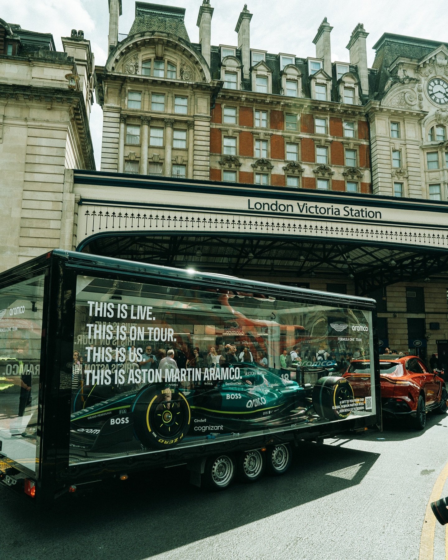 Aston Martin Aramco F1 Transparent Showcase Trailer by The Clear Idea parked at UK urban tour stop with branded vinyl wrap