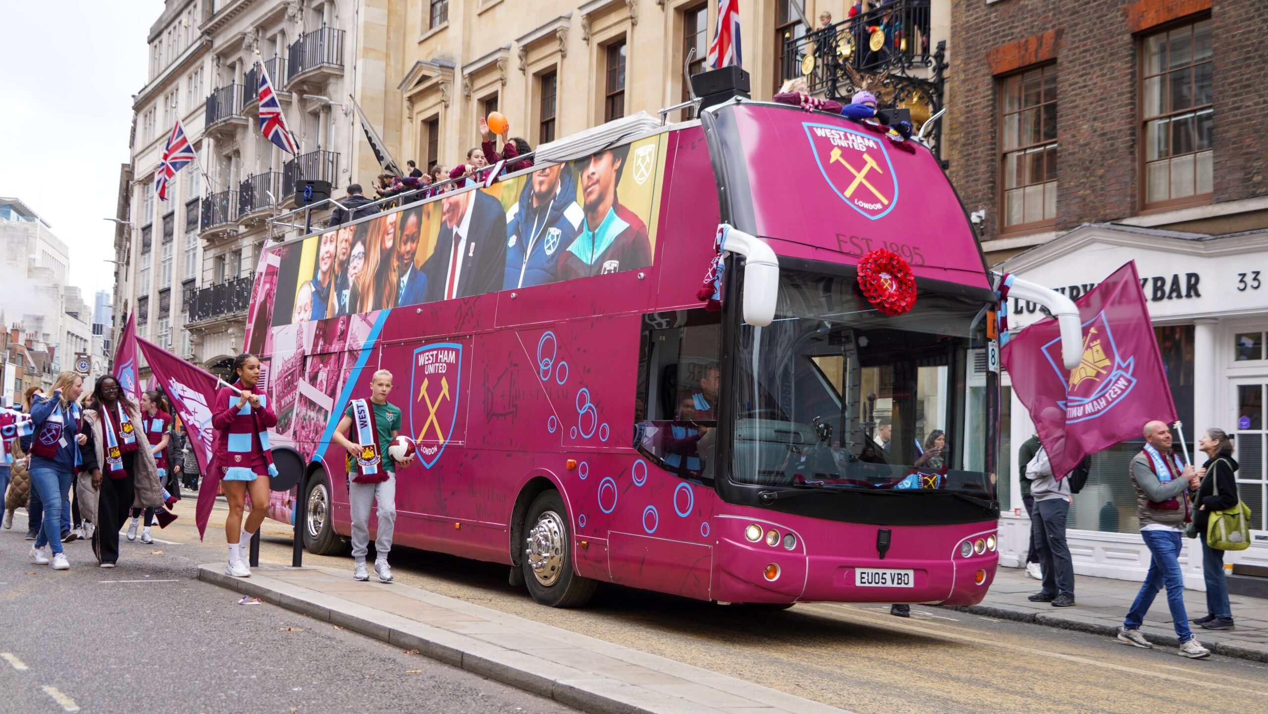 LED HyperBus promotional bus at Lord Mayor's Show London with West Ham Foundation branding LED screens and fans on open top deck waving flags